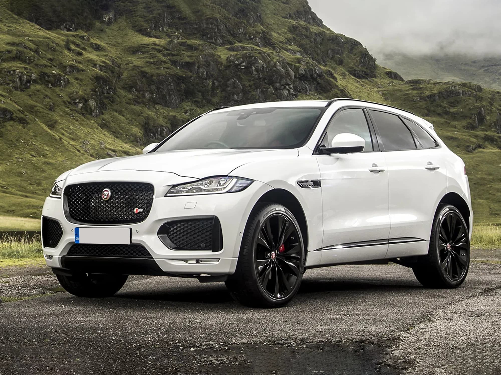 White Jaguar F-Pace with black wheels, viewed from the front and side