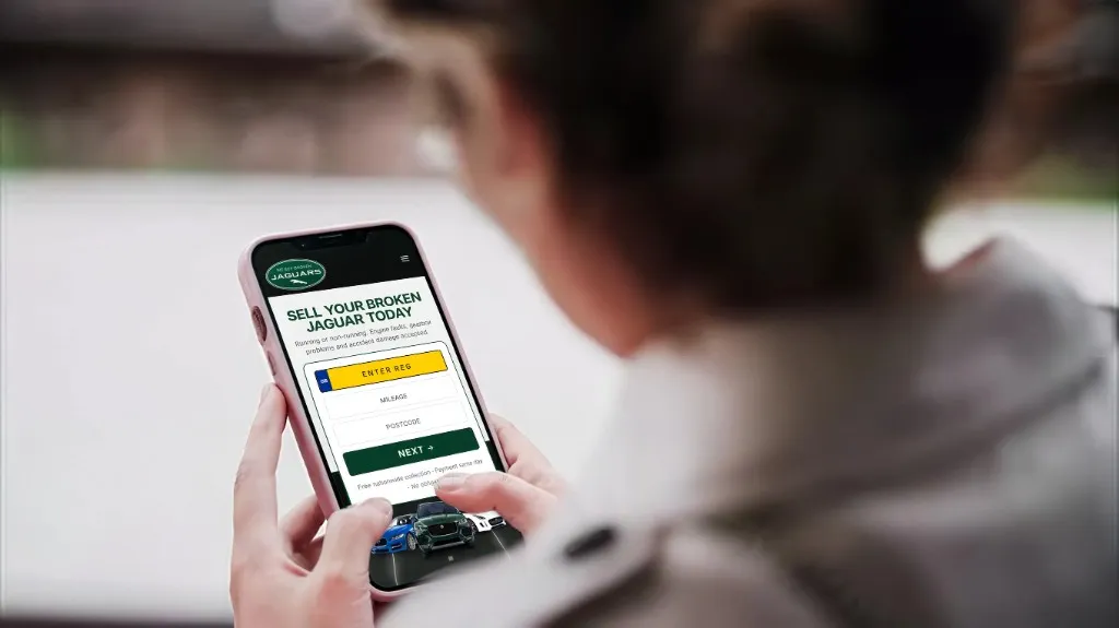 Person entering their Jaguar details on the We Buy Broken Jaguars website on a phone